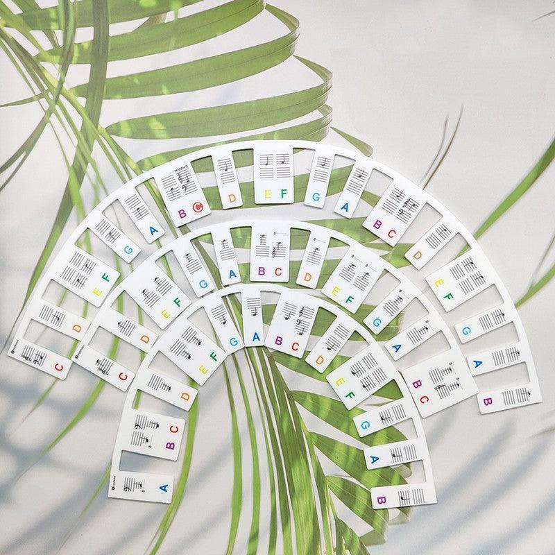 Multicolour silicone removable piano keyboard note labels placed on black and white keys — view 3