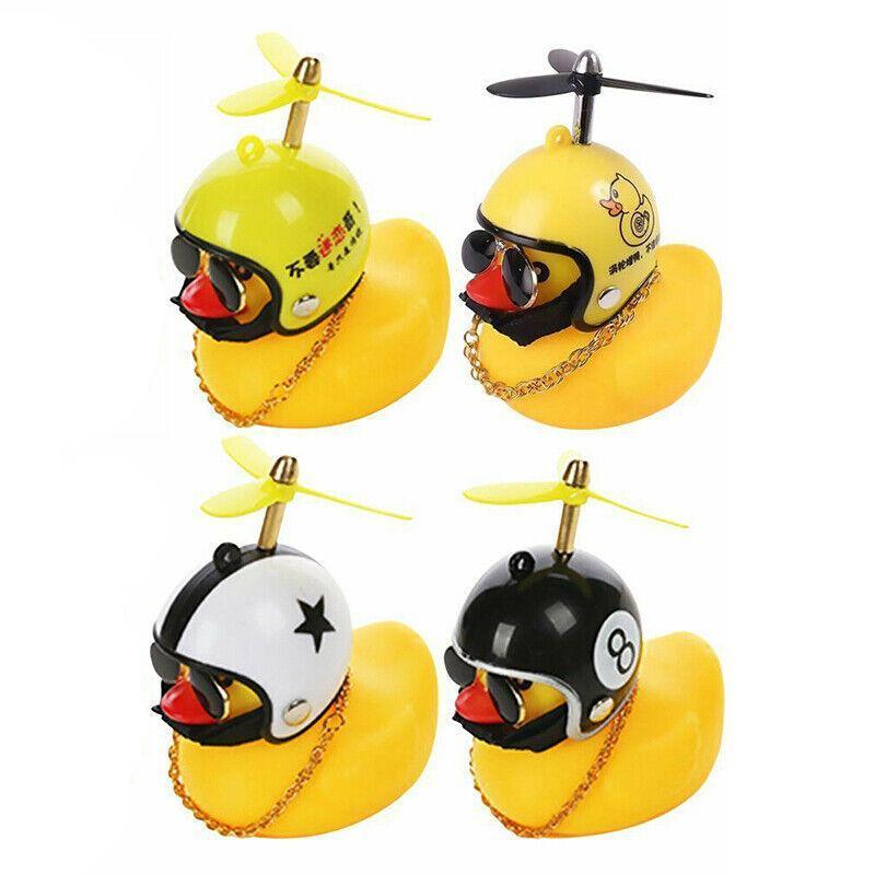 Yellow rubber duck dashboard ornament with helmet and light up feature for cars and bicycles.