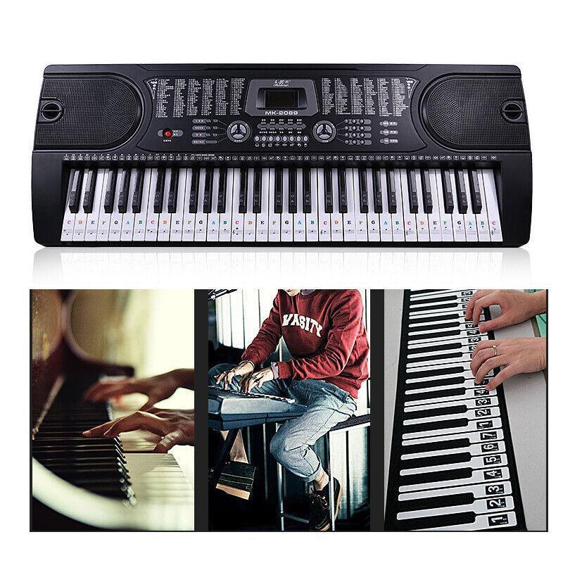 Transparent piano note stickers applied to a full-size keyboard showing staff notation — view 4