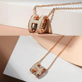 Oval enamel letter necklace in rose gold delicate clavicle chain with vibrant H initial pendant