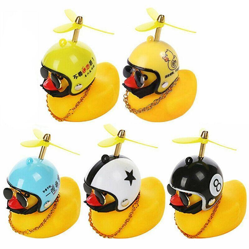 Yellow rubber duck dashboard ornament with helmet and light up feature for cars and bicycles. — view 2