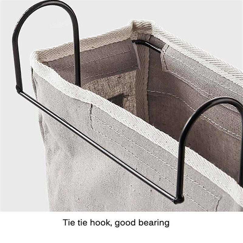 Canvas bedside storage caddy hanging on a bed frame holding books and remote controls — view 4