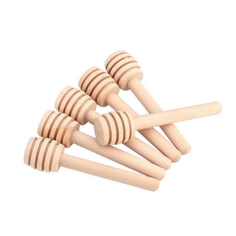 Mini wooden honey dipper sticks with carved grooves arranged together for drizzling syrup and party favors — view 2