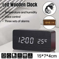 Modern minimalist wooden digital alarm clock with bright LED time and temperature display.