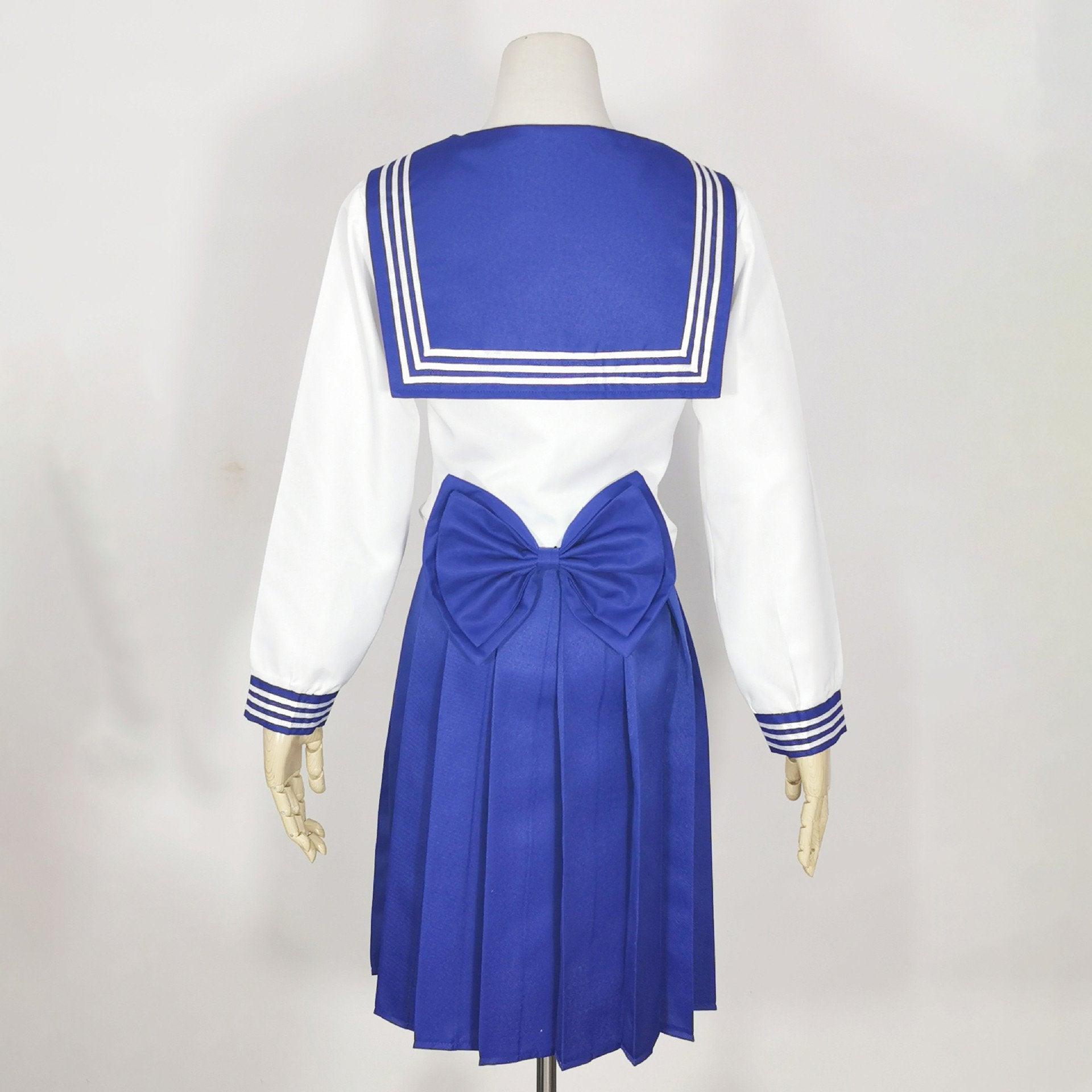 Sailor Warrior anime cosplay costume with navy pleated skirt, white bodice, and red bow. — view 4
