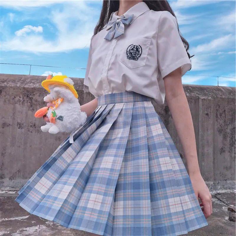 Women's high waist pleated plaid skirt in classic school uniform style on a model — view 3