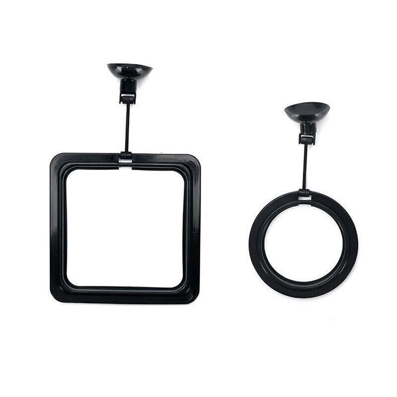 Black floating fish feeding ring with adjustable suction cup attached to glass aquarium — view 2