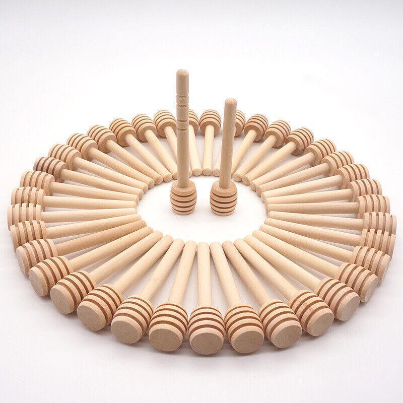 Mini wooden honey dipper sticks with carved grooves arranged together for drizzling syrup and party favors — view 4
