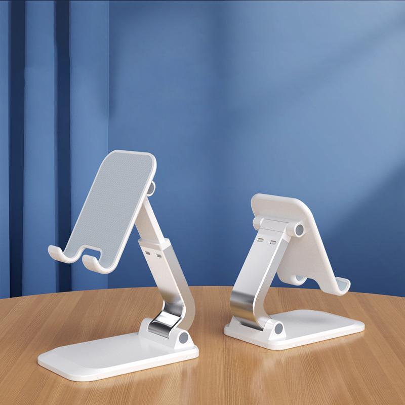 Adjustable foldable tablet stand in silver aluminum securely holding a mobile phone on a desk — view 4