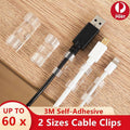 Set of twenty self-adhesive plastic cable management clips organizing power cords on a wooden desk
