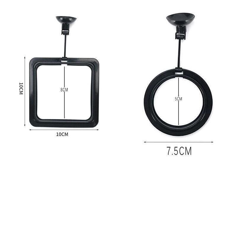 Black floating fish feeding ring with adjustable suction cup attached to glass aquarium — view 3