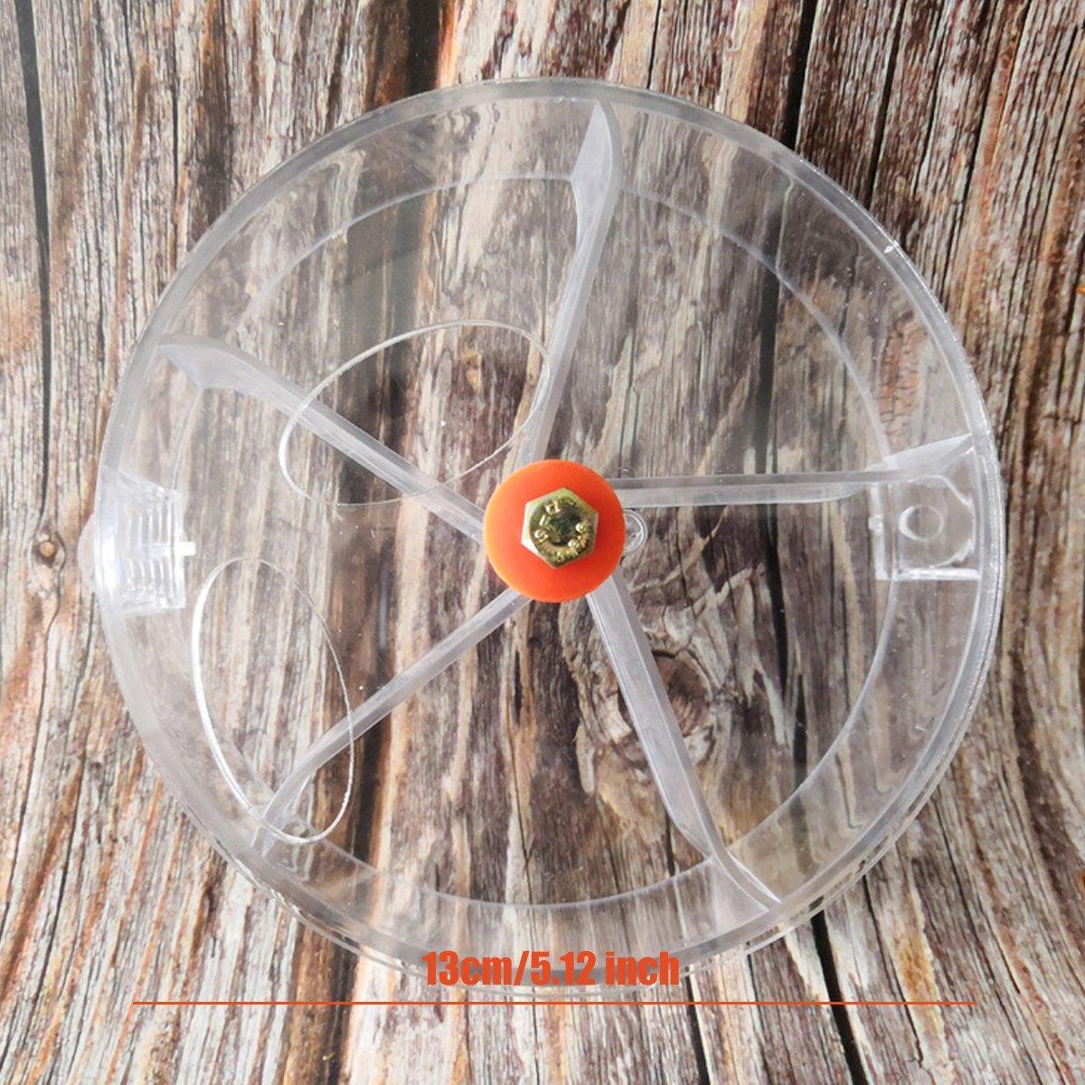 Interactive parrot foraging wheel toy in purple, mounted securely to a bird cage with clear compartments — view 3