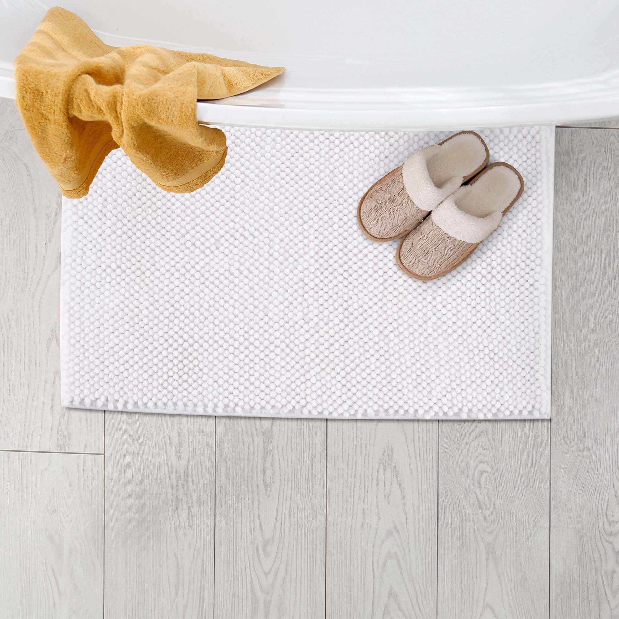 Plush solid white washable bath mat made of thick absorbent polyester for bathroom floors — view 4