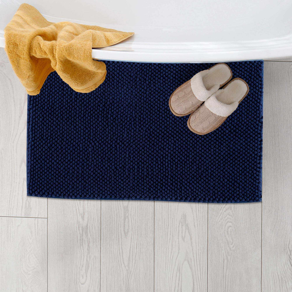 Plush navy blue washable bath mat with thick polyester shag texture on a bathroom floor — view 4