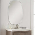 Round contemporary wall mirror with a metallic silver-gray aluminum frame on a blank wall