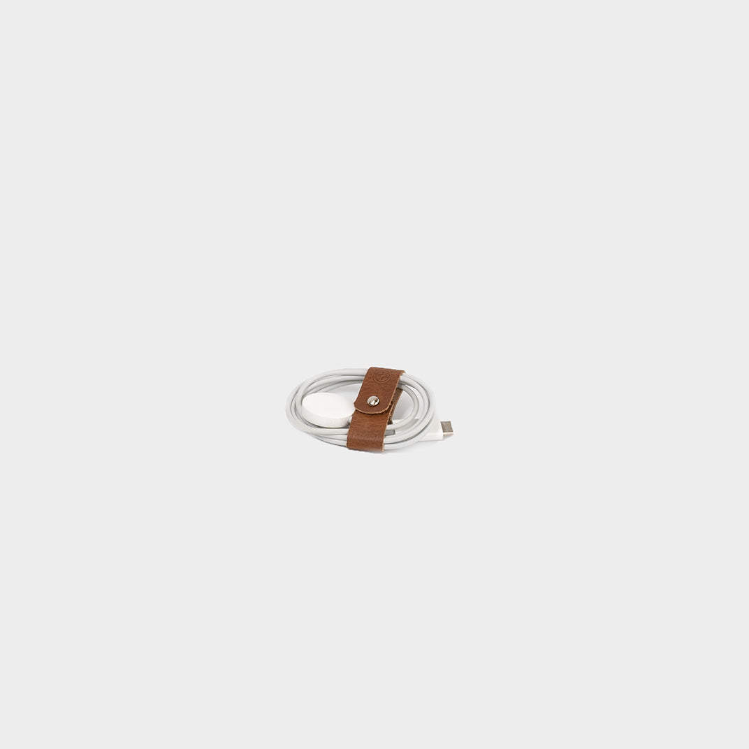 Premium leather cord organizer sets with metal snap closures securely holding folded white charging cables — view 3