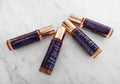 Pulse point aromatherapy gift set featuring four natural essential oil glass roll-on bottles in packaging