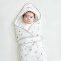 White cotton newborn baby swaddle wrap with lively tiger print and cozy protective hood