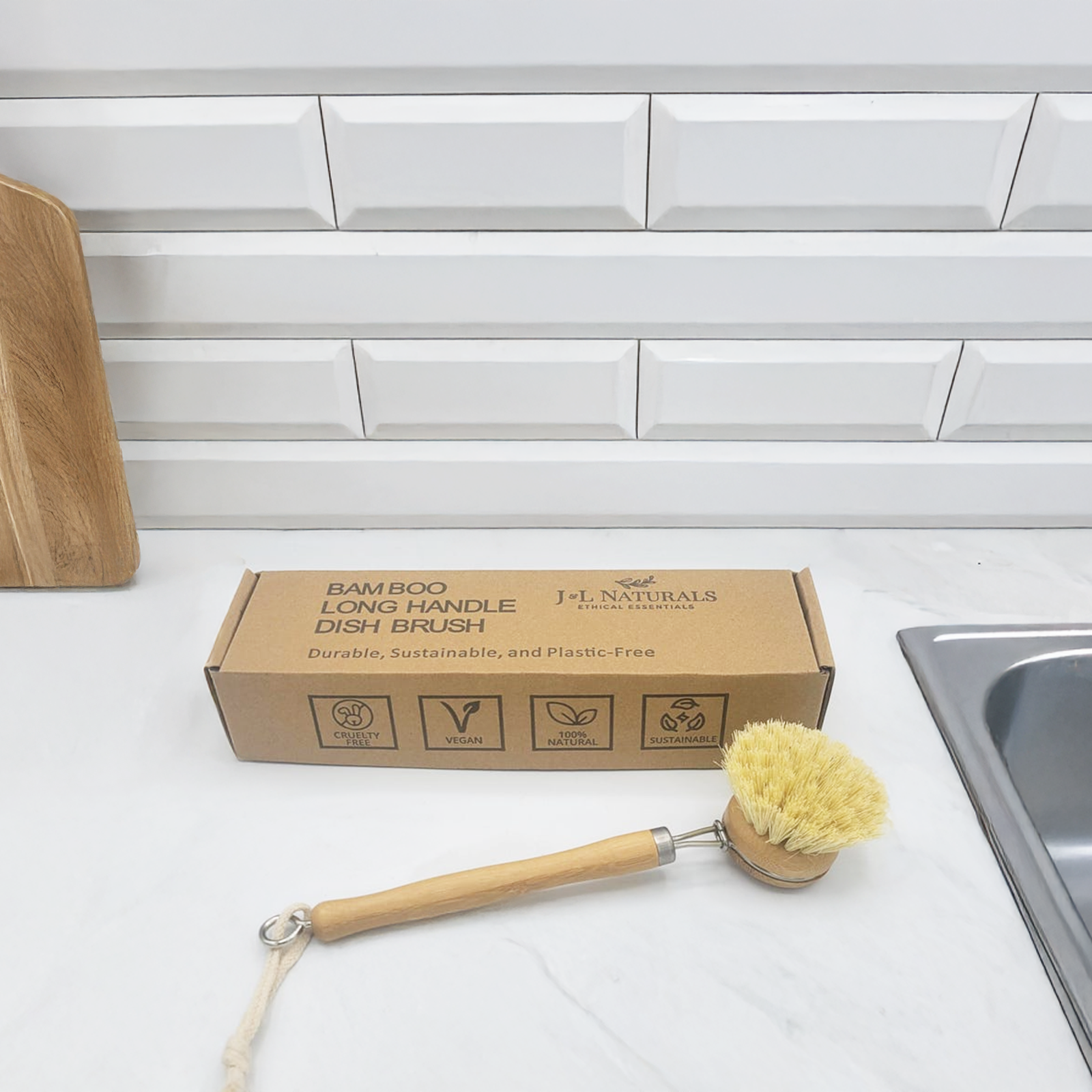 Bamboo long handle dish brush with natural sisal bristles on a kitchen counter — view 3