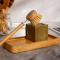 Bamboo long handle dish brush with natural sisal bristles on a kitchen counter
