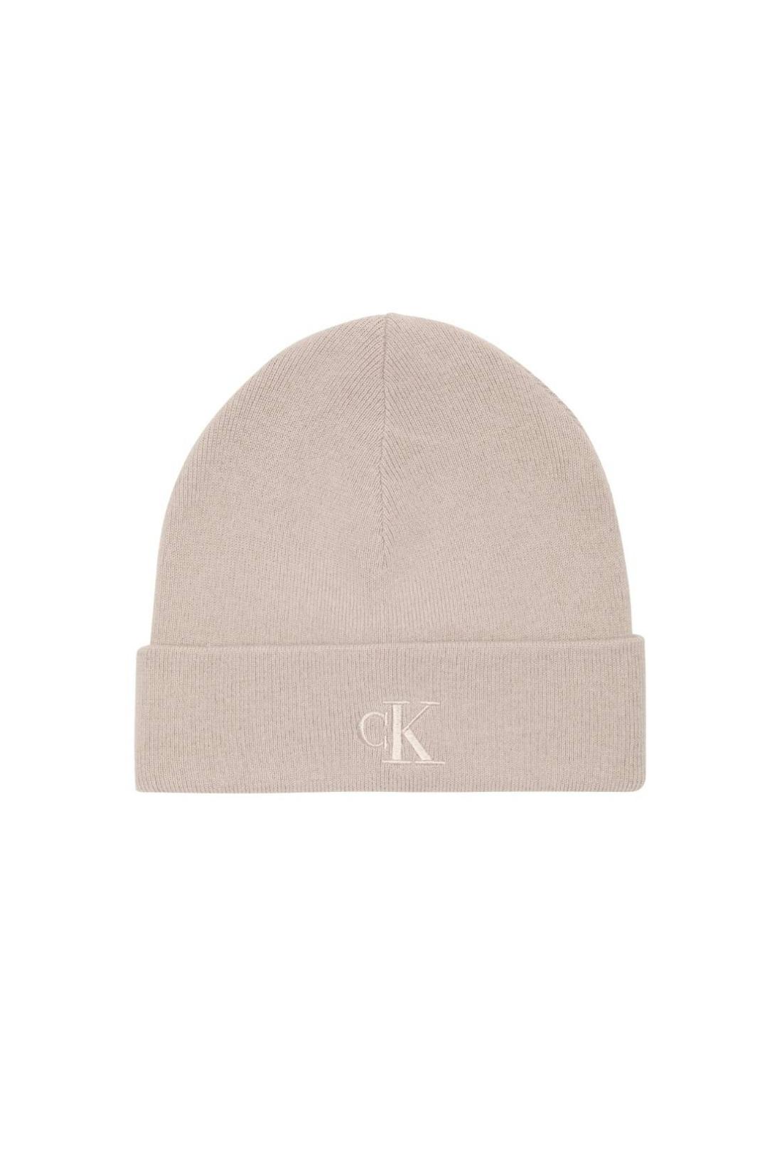 Men's beige knitted beanie hat with fold-over cuff and embroidered monogram logo on the front — view 4