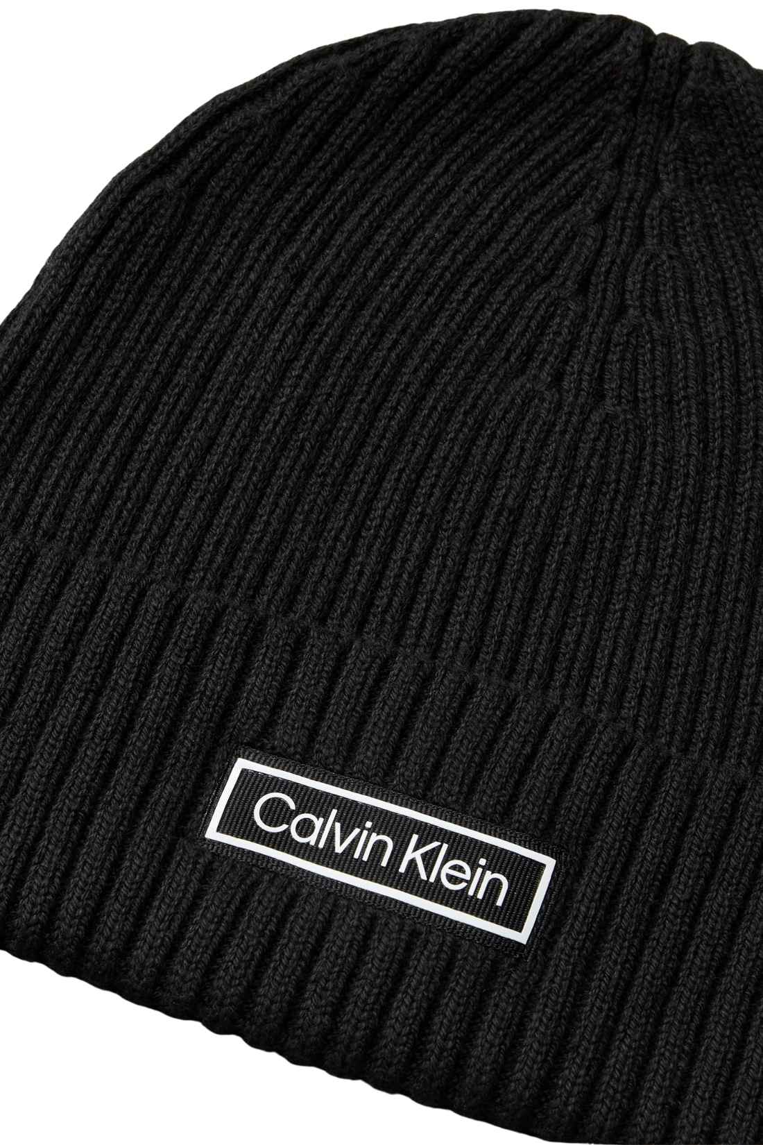 Men's black ribbed knit Calvin Klein beanie with a front logo patch and folded cuff — view 9