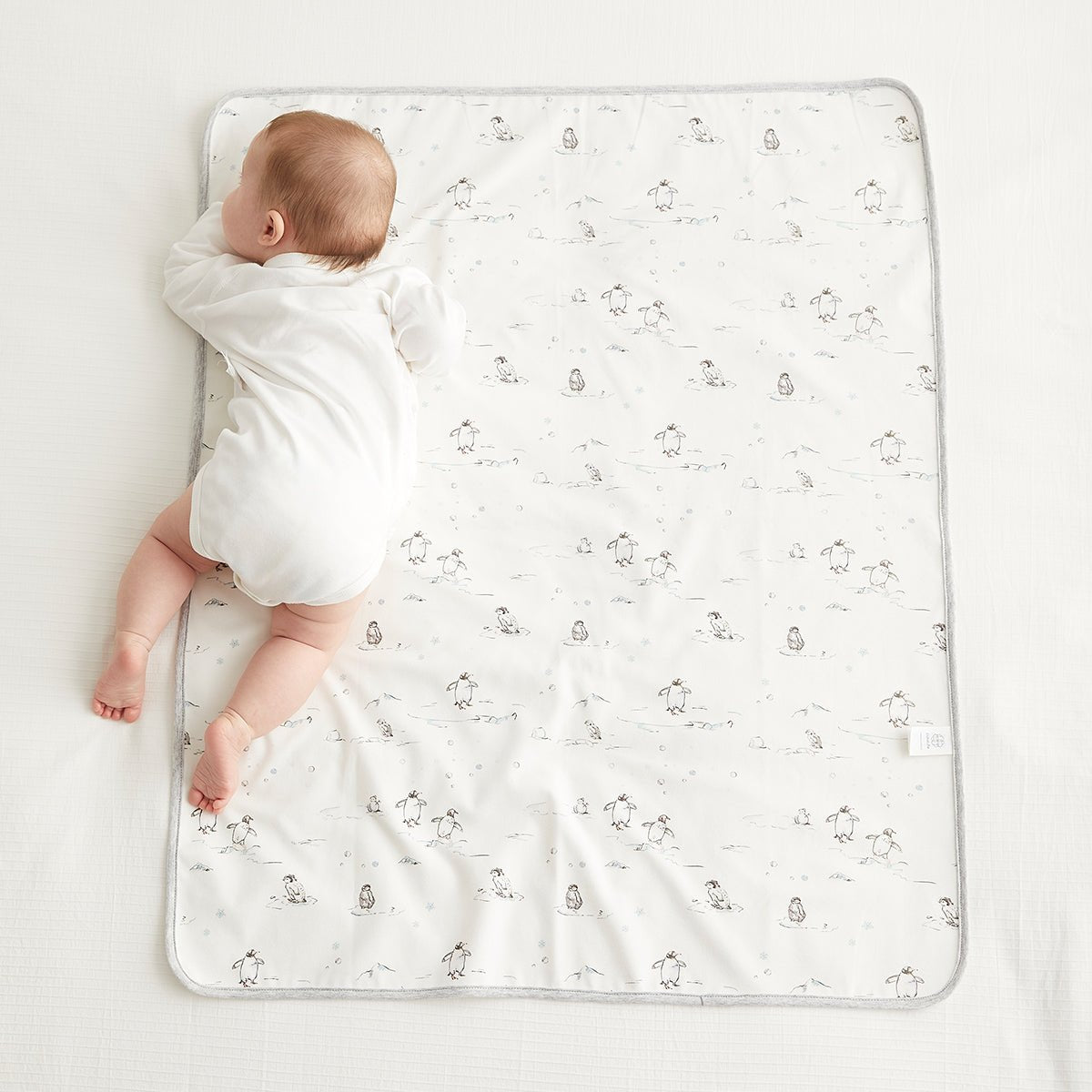 Waterproof baby changing mat in crisp white, lightweight portable pad for newborn diaper changes