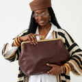 Radiant soft clutch bag in delicate pink faux leather with clasp closure and shoulder strap