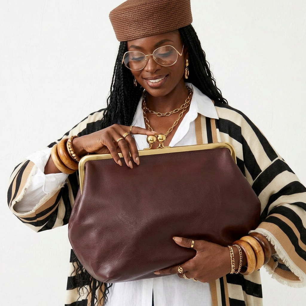 Radiant soft clutch bag in delicate pink faux leather with clasp closure and shoulder strap