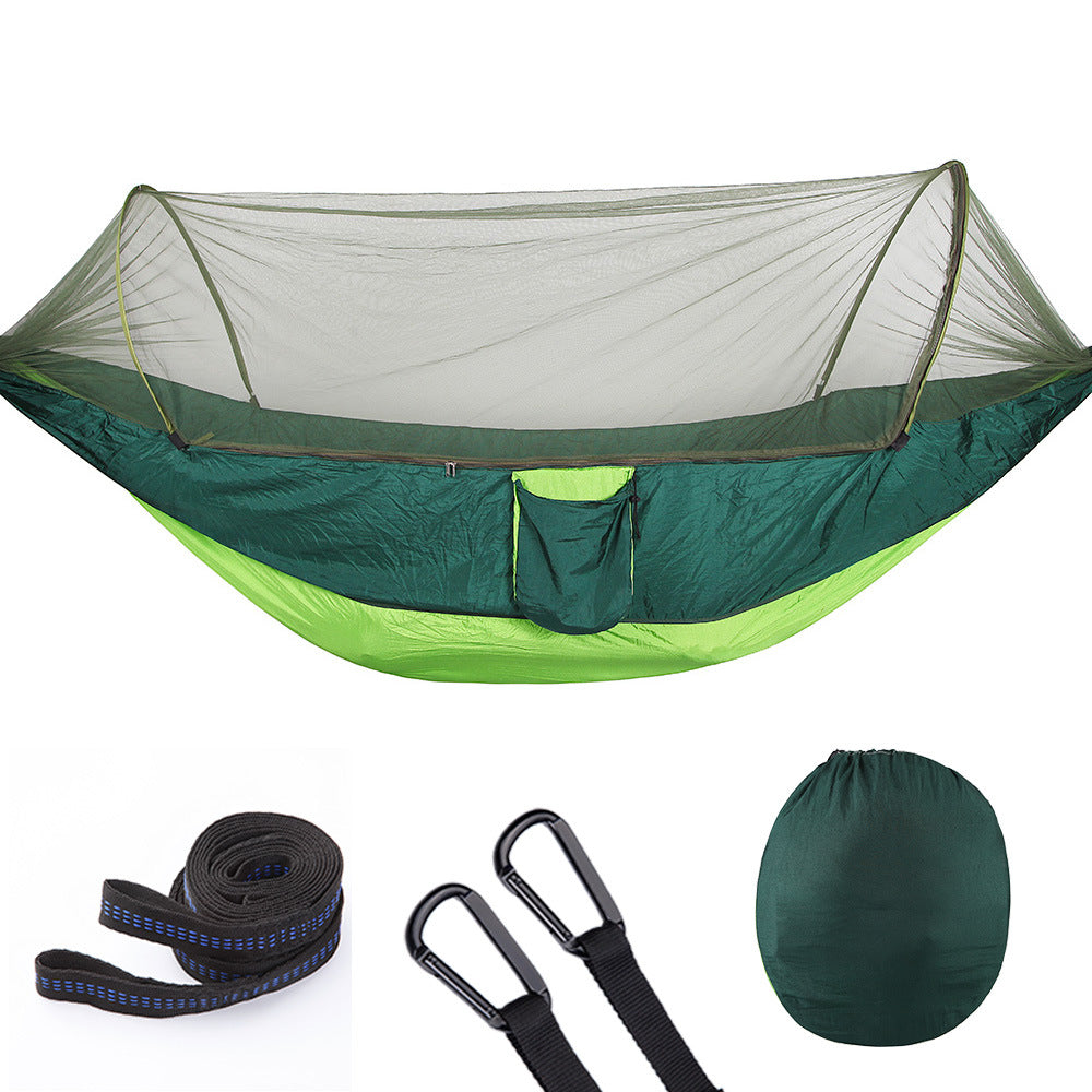 Portable nylon camping hammock with mosquito net, tree straps, and compact black storage bag
