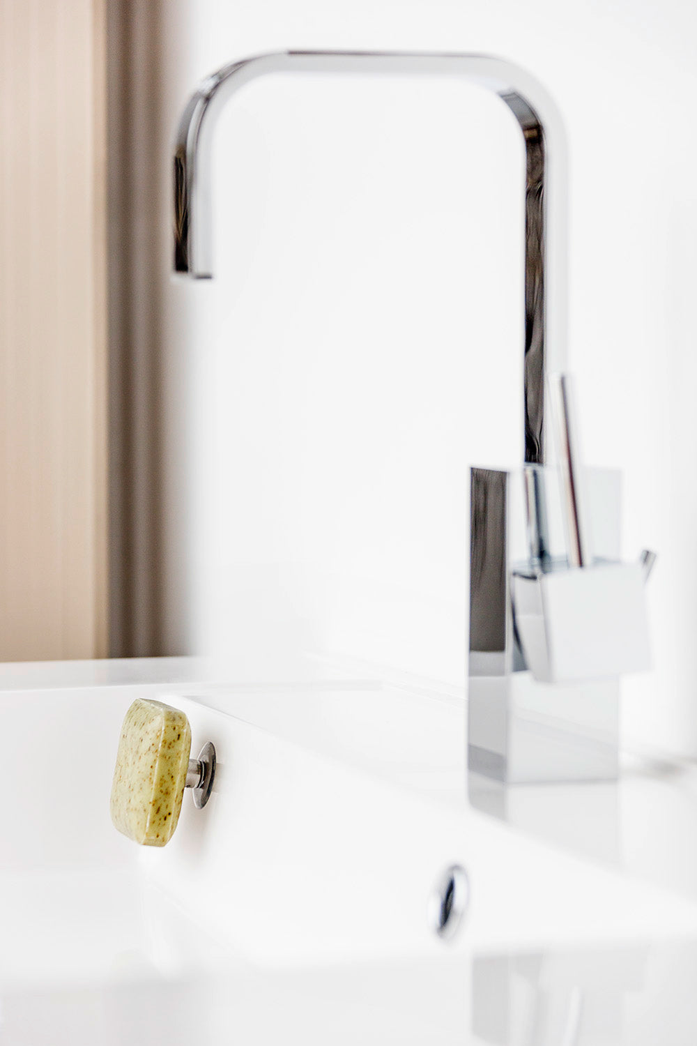 SAVONT magnetic floating soap holder attached to a white bathroom sink with a solid soap bar — view 2