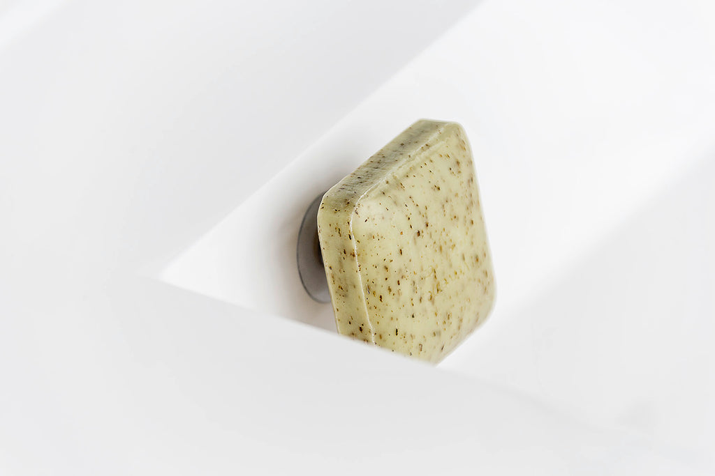 SAVONT magnetic floating soap holder attached to a white bathroom sink with a solid soap bar — view 9