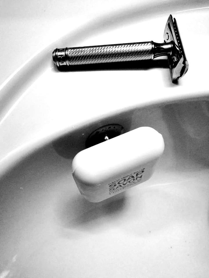 SAVONT magnetic floating soap holder attached to a white bathroom sink with a solid soap bar — view 4