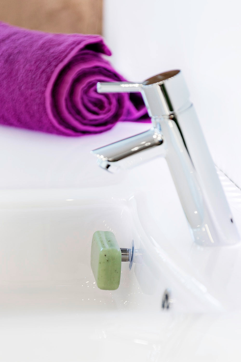 SAVONT magnetic floating soap holder attached to a white bathroom sink with a solid soap bar — view 7