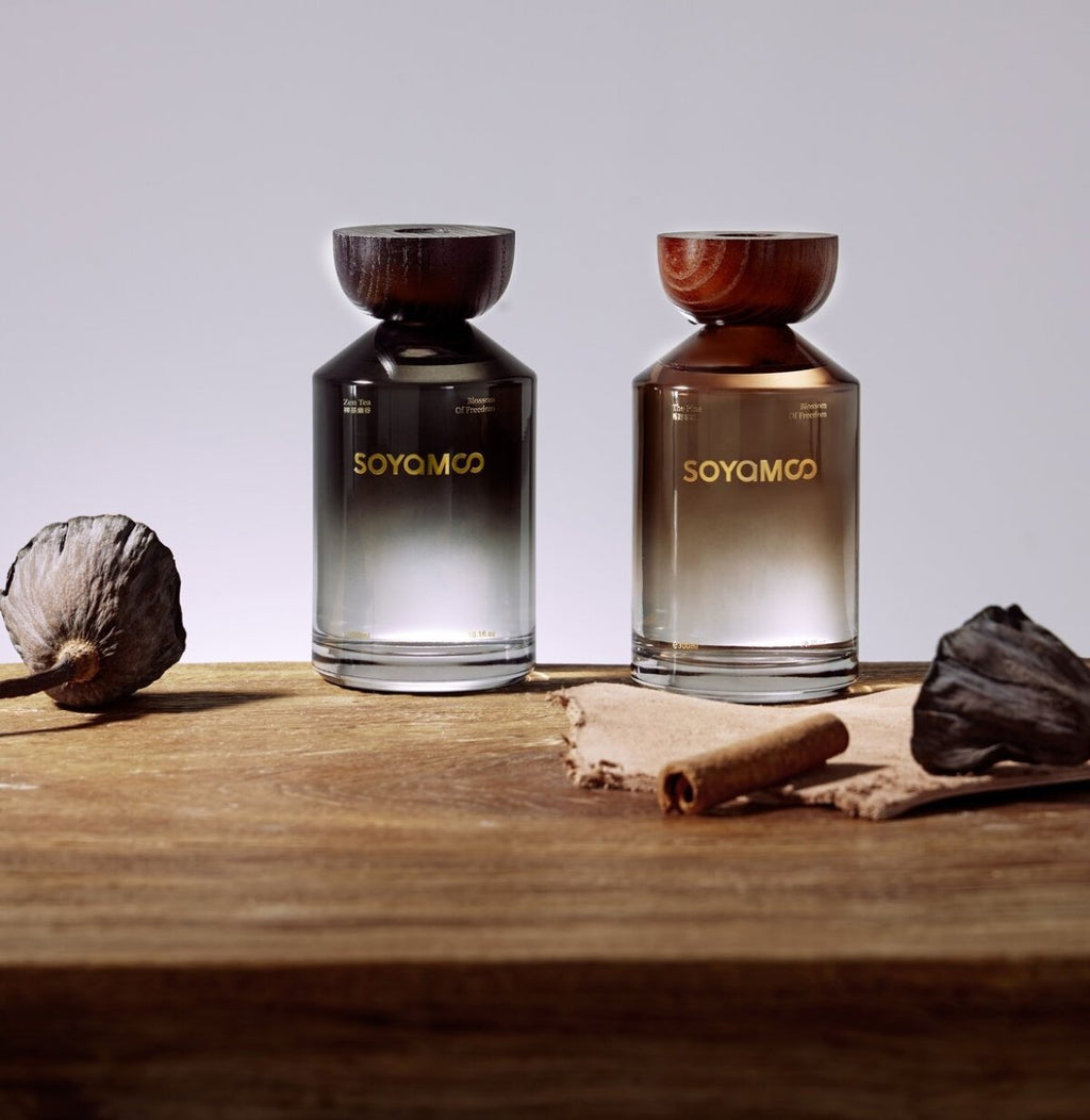 Warm brown angled shoulder glass reed diffuser with wooden cap and luxury woody fragrance — view 2