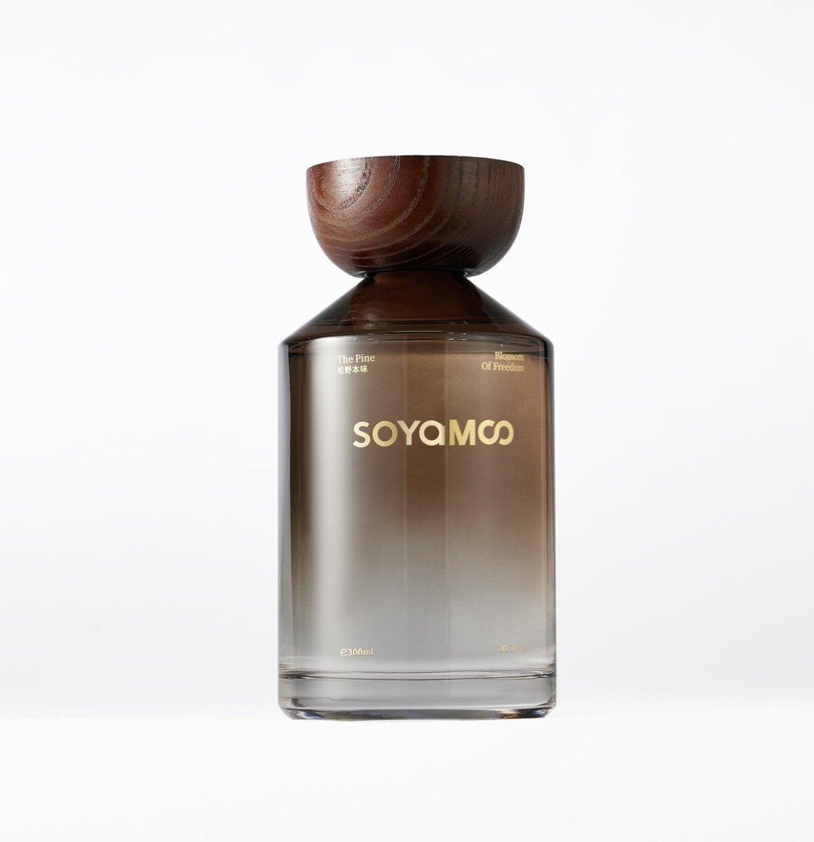 Warm brown angled shoulder glass reed diffuser with wooden cap and luxury woody fragrance — view 4