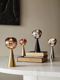 Melt portable dimmable table lamp featuring a glossy molten glass shade on a modern nightstand