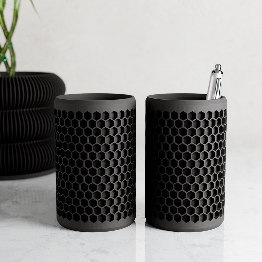Modern geometric honeycomb pencil holder organizing pens and accessories on a stylish office desk setup.