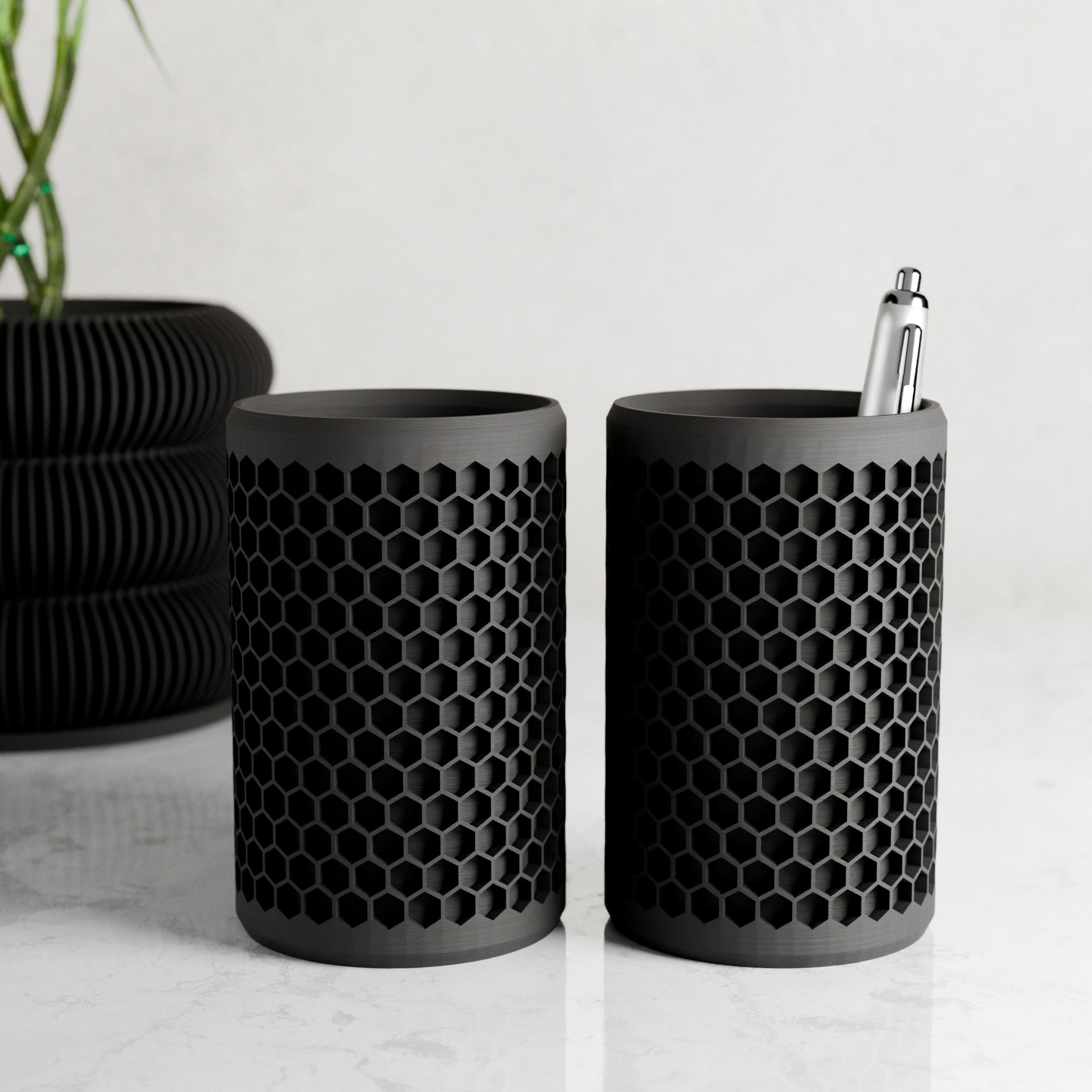 Modern geometric honeycomb pencil holder organizing pens and accessories on a stylish office desk setup.