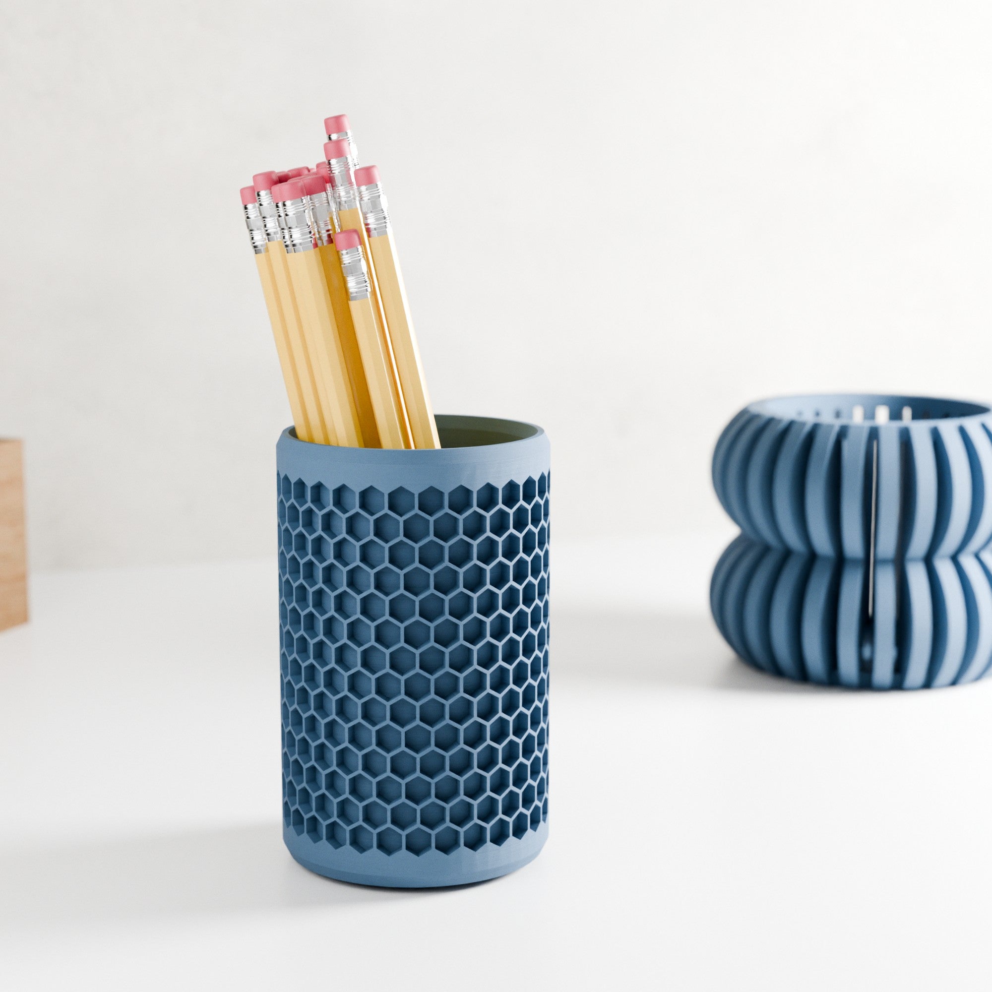 Modern geometric honeycomb pencil holder organizing pens and accessories on a stylish office desk setup. — view 4