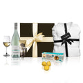 Luxury white wine hamper in black box with plush robe, hand cream, cookies, and wine.