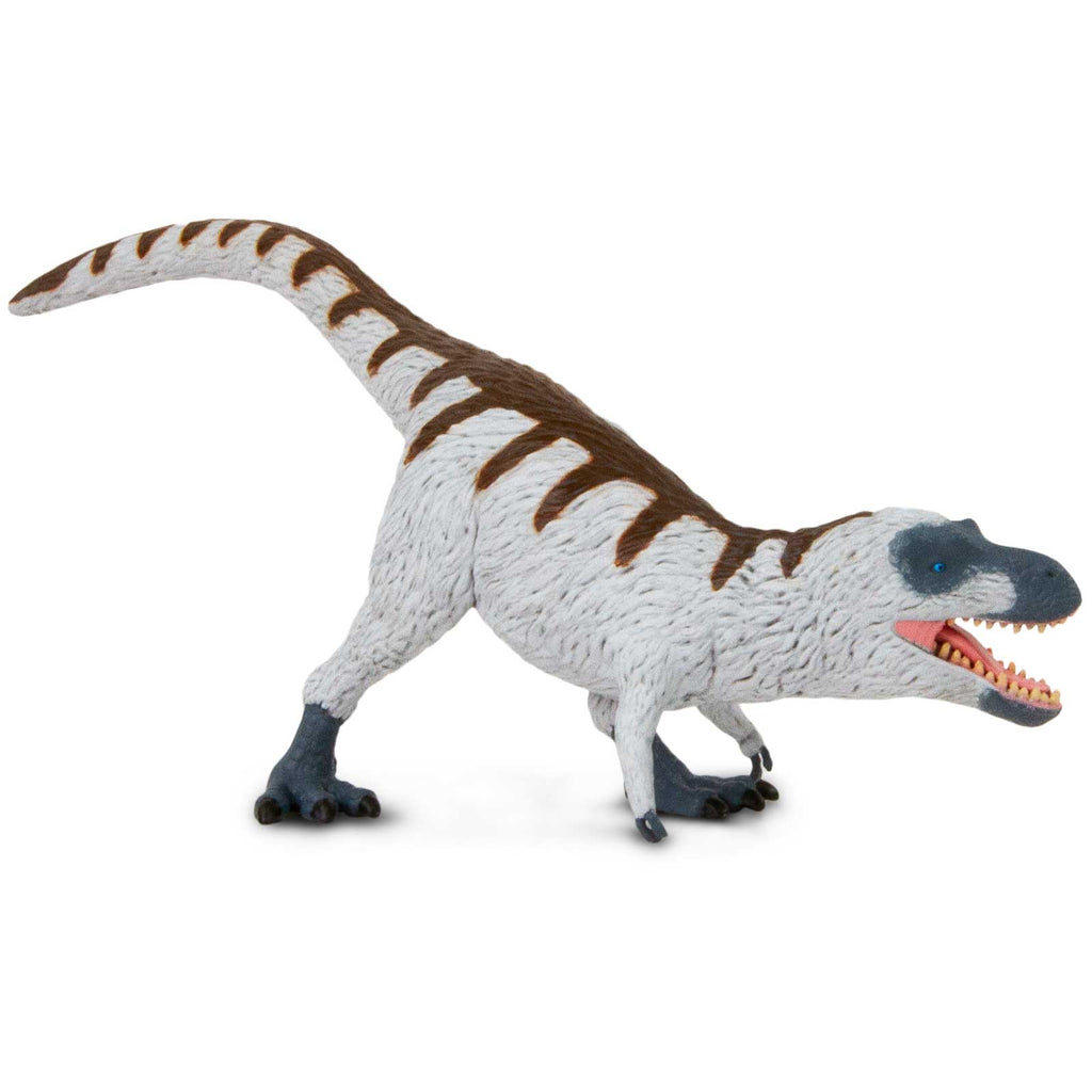 Nanuqsaurus toy dinosaur figure with white feathers and blue-gray skin in a dynamic standing pose