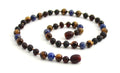 Gemstone necklace featuring raw cherry amber, lapis lazuli, and brown tiger eye beads.