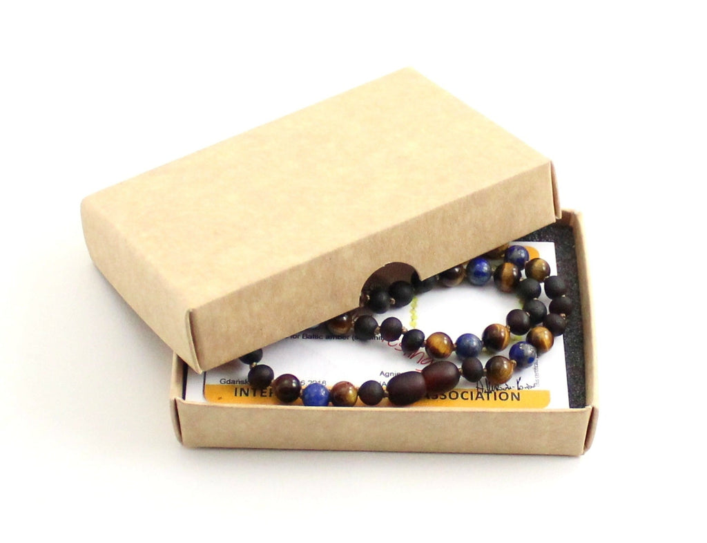 Gemstone necklace featuring raw cherry amber, lapis lazuli, and brown tiger eye beads. — view 2