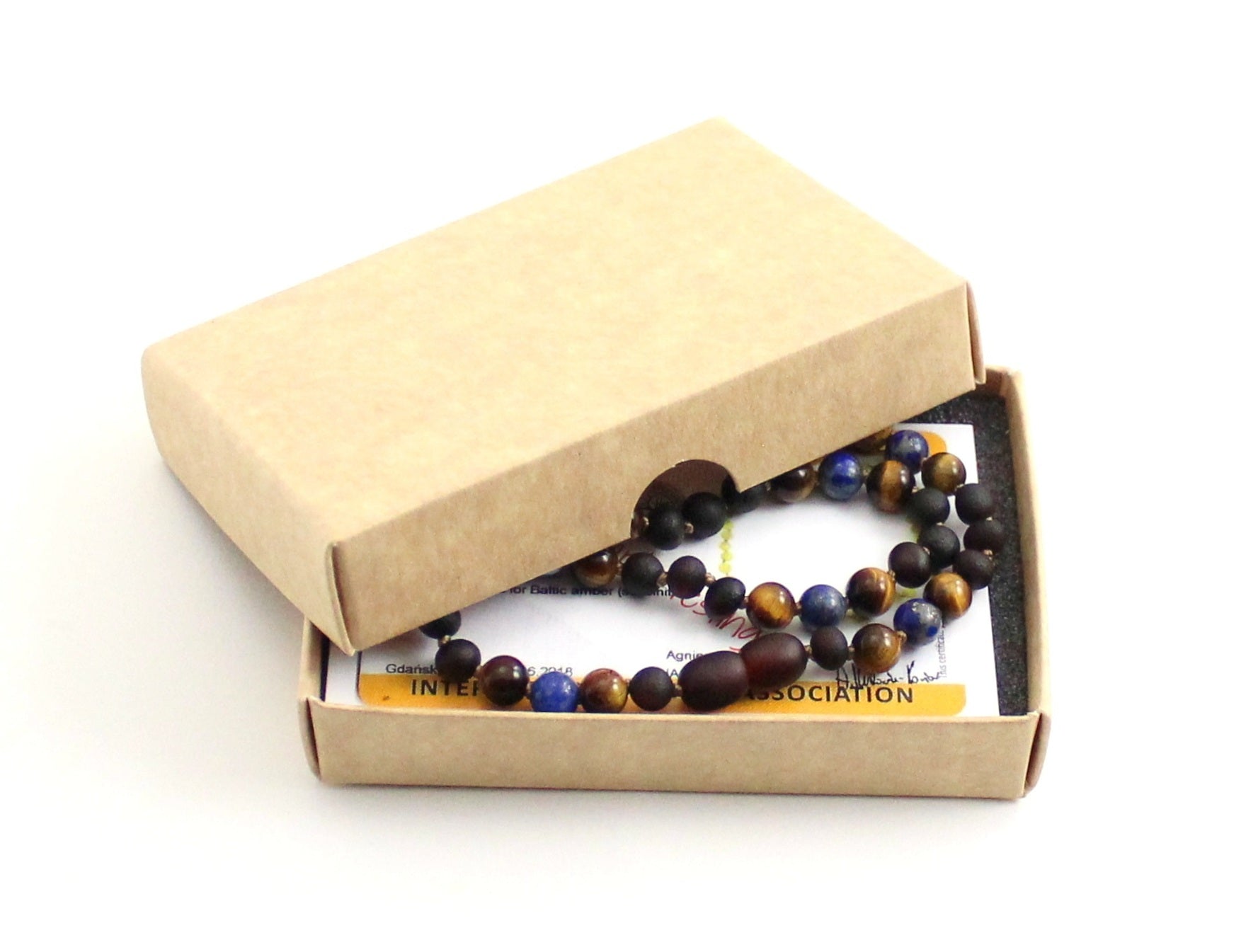 Gemstone necklace featuring raw cherry amber, lapis lazuli, and brown tiger eye beads. — view 2