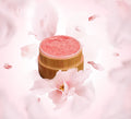 Natural blush loose powder in reusable bamboo container with plastic sifter and soft application puff.