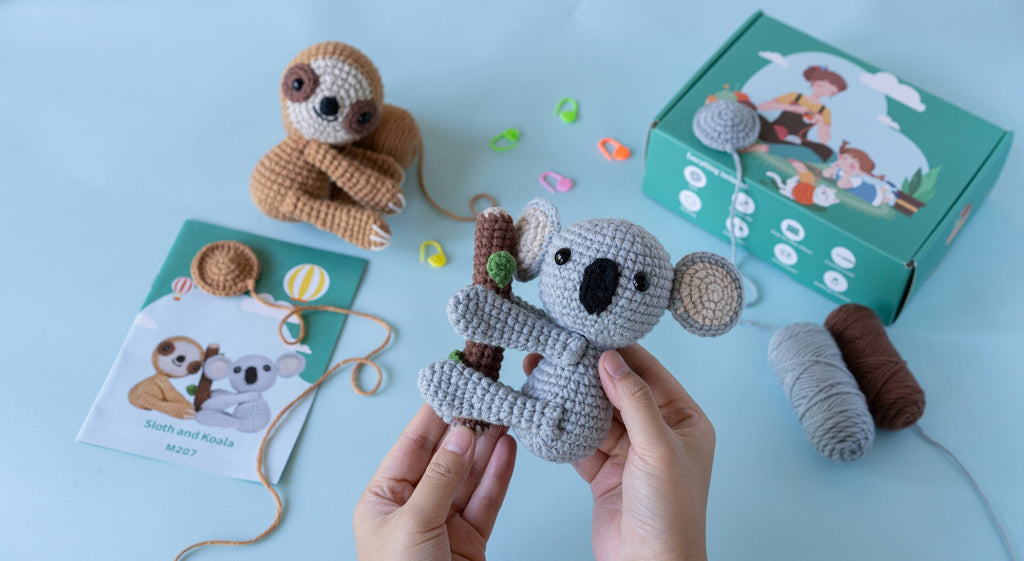 Amigurumi sloth and koala DIY crochet kit with yarn, hook, stuffing, and instruction brochure — view 5