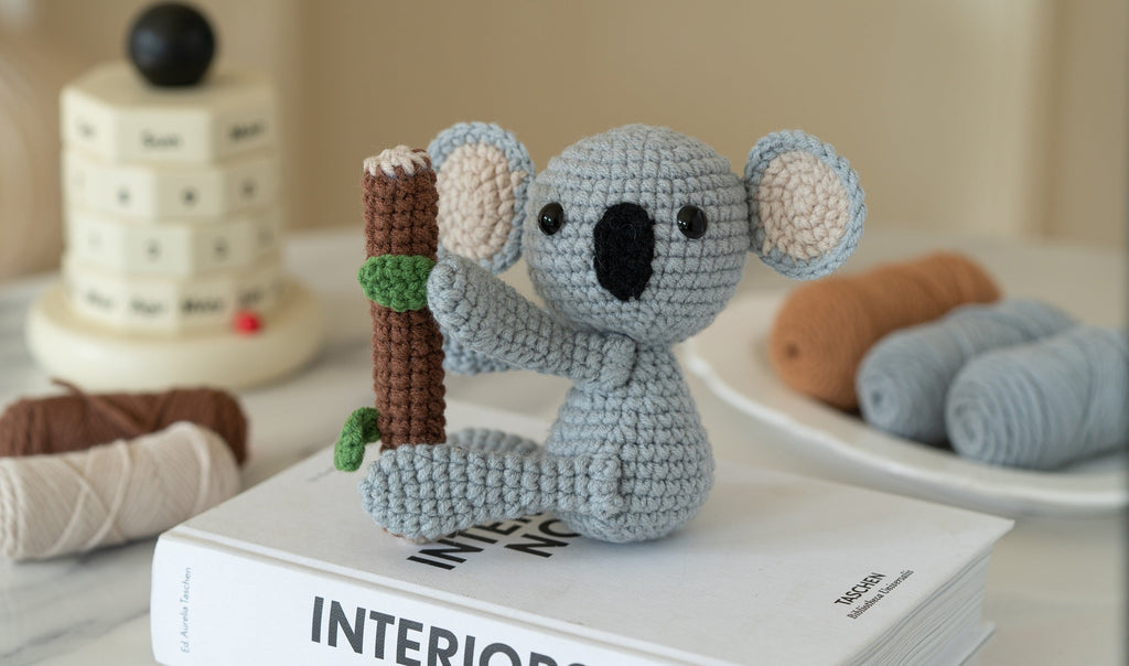 Amigurumi sloth and koala DIY crochet kit with yarn, hook, stuffing, and instruction brochure — view 3