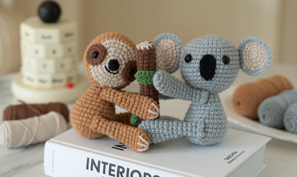Amigurumi sloth and koala DIY crochet kit with yarn, hook, stuffing, and instruction brochure