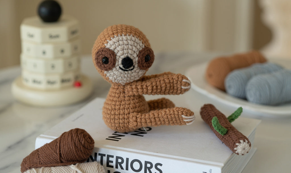Amigurumi sloth and koala DIY crochet kit with yarn, hook, stuffing, and instruction brochure — view 2